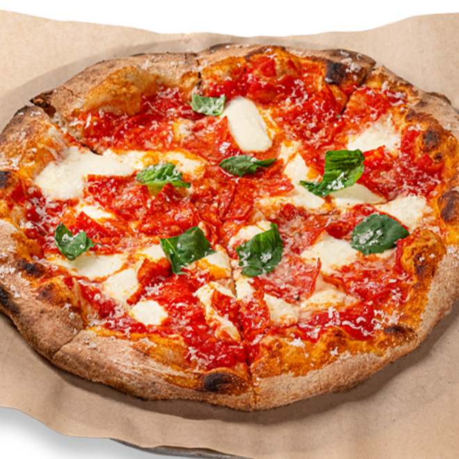 A fresh, round pizza on parchment paper, topped with tomato sauce, mozzarella slices, pepperoni, and fresh basil leaves, showcasing a crispy, golden crust.